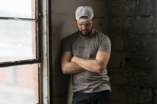 Young man wearing a gray tee with the 41 North Co logo on the chest